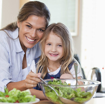 mother and daughter preparing salad